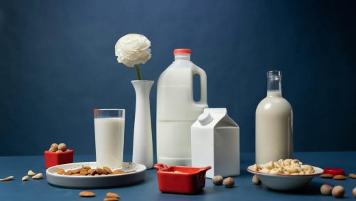 almond and hazelnut milks in studio on blue background