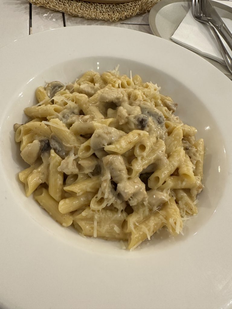 Gluten-free pasta with mushroom, chicken, and cheese from Amora Pizza in Doha, Qatar.