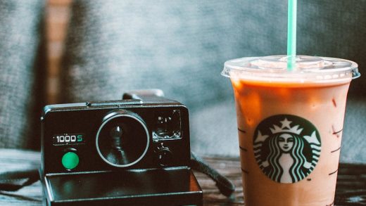 Starbucks gluten-free drink next to a camera.