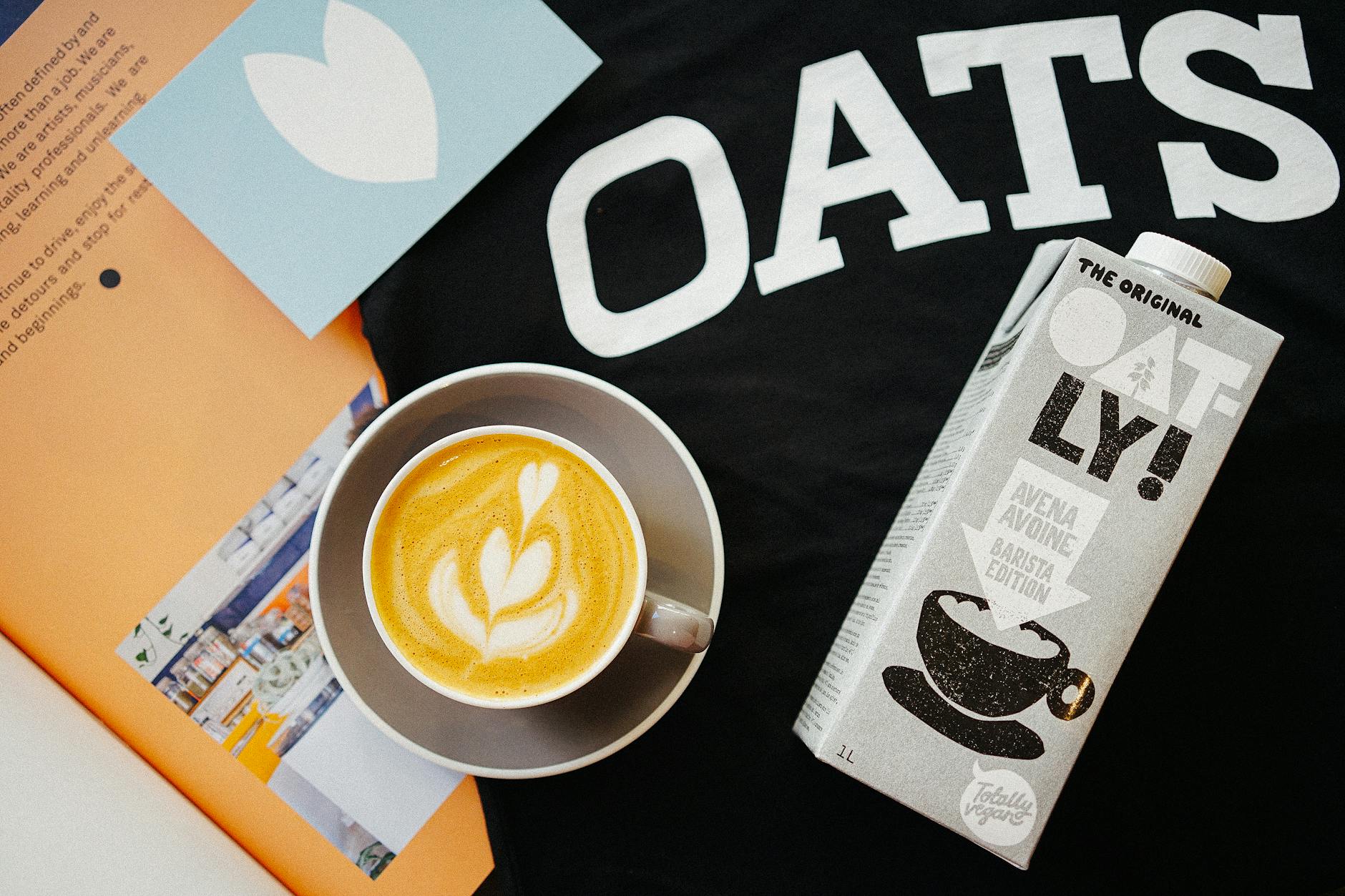 Cup of coffee and Oatly oat milk.
